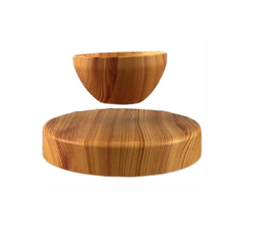 Floating bonsai with magnetic levitation, and woodgrain base for modern home décor.